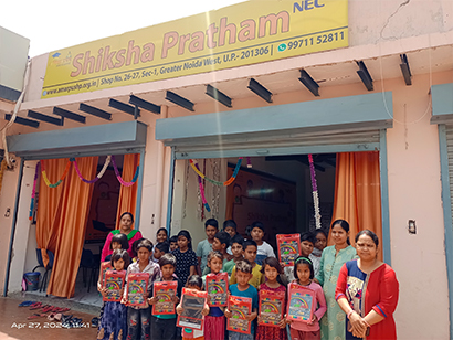 Children receiving educational supplies during school kit distribution program