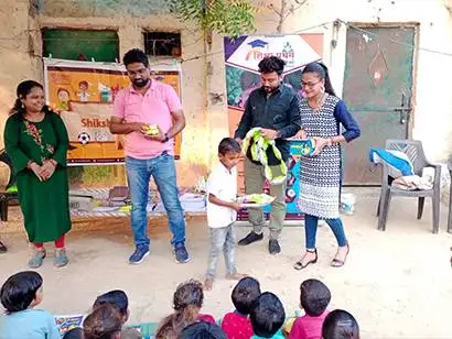 Students happily receiving school kits for their education needs
