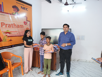 Students receiving new school uniforms during distribution program