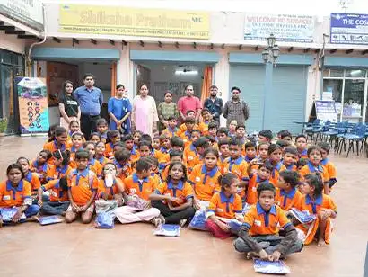 Children happily receiving school uniforms from NGO volunteers